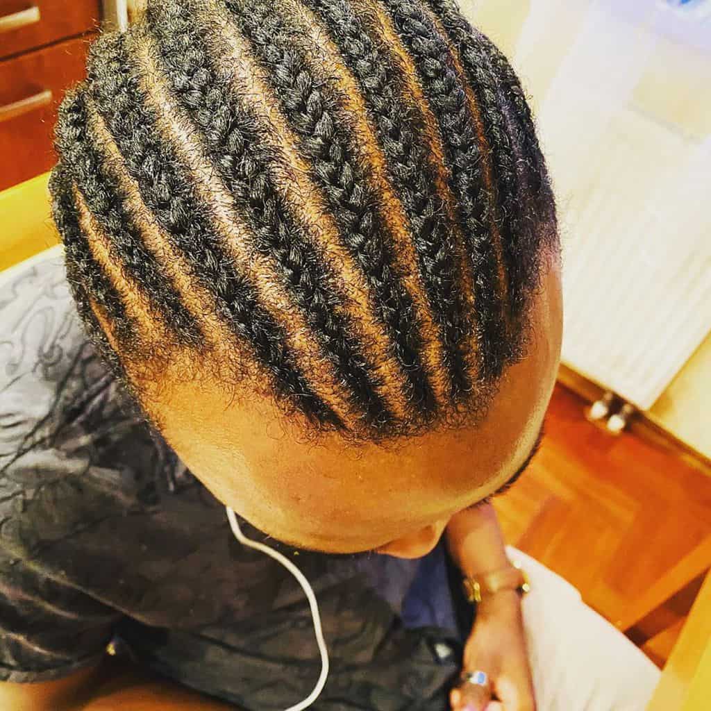 Men’s Cornrows Hairstyle With Thick Braids On The Top And Thin Brains Around The Temple
