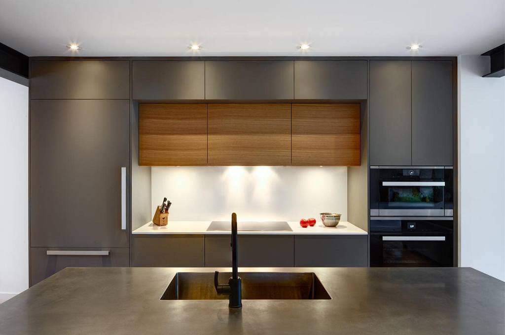 sleek minimalist kitchen with gray cabinets and stone island sink 