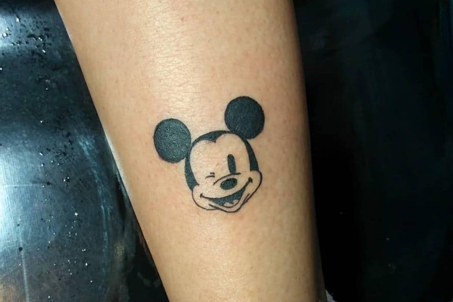 Matching tattoos of Minnie and Mickey Mouse by tattoo