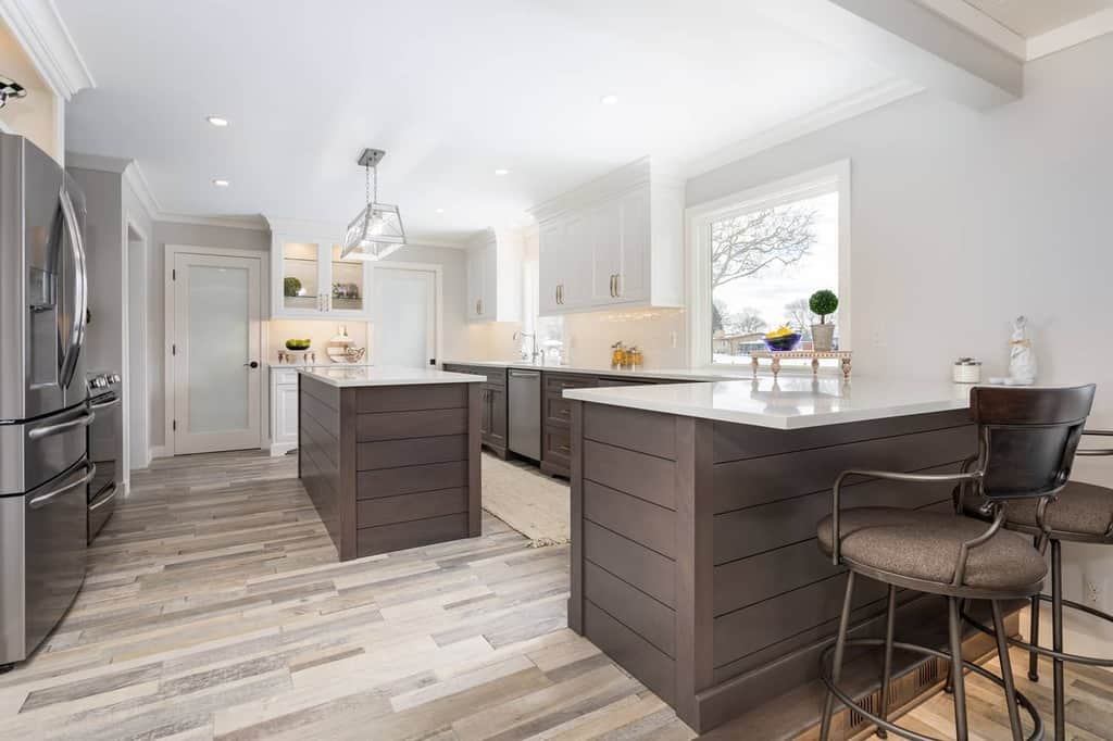 natural wood and white colored cabinets large kitchen breakfast bar island vinyl wood flooring 