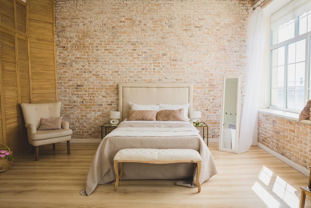 apartment bedroom with exposed brick wall