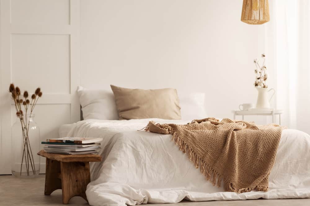 beige colored bedroom platform bed brown foot stool