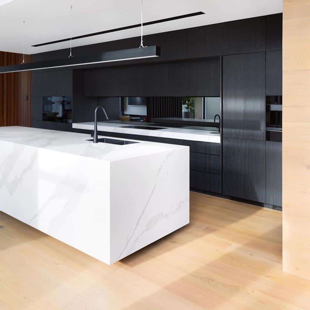 sleek modern kitchen black cabinets white marble island 