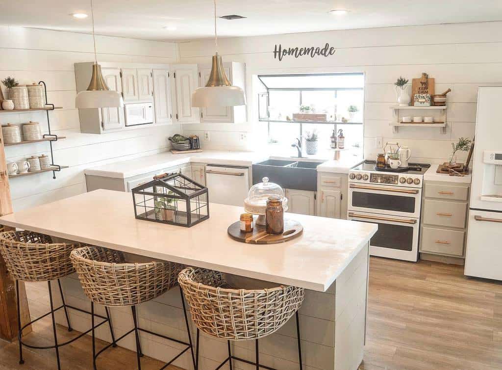 white shiplap wall country kitchen white cabinets copper accents white island weaved seating 