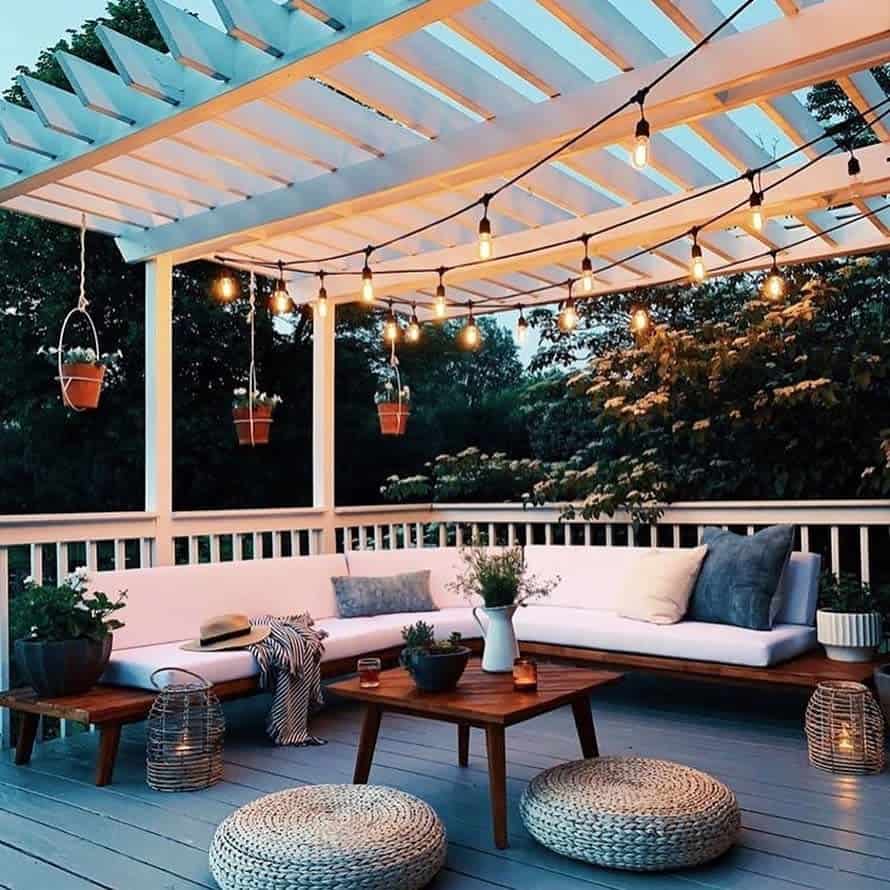 gray wood deck timber furniture hanging lights pot plants