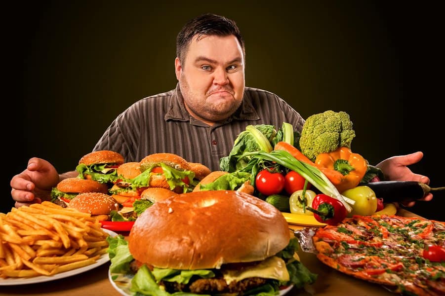 Overweight male with lots of foods