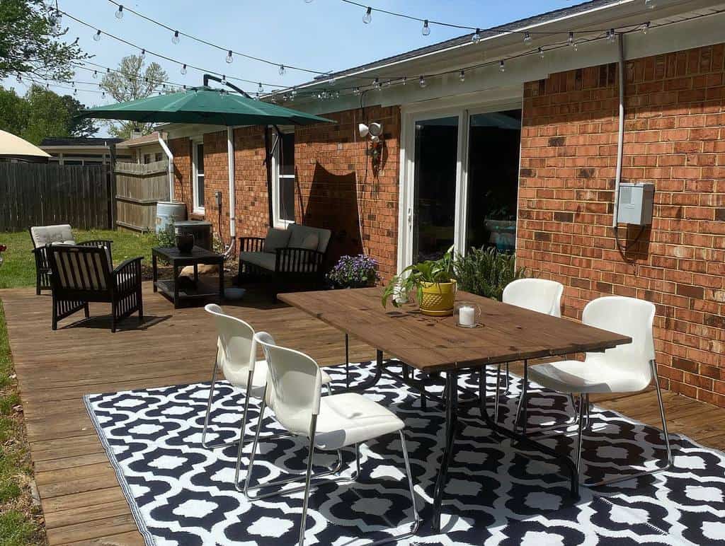 wood patio wood table with white chairs black table and chairs green umbrella pattern floor rug