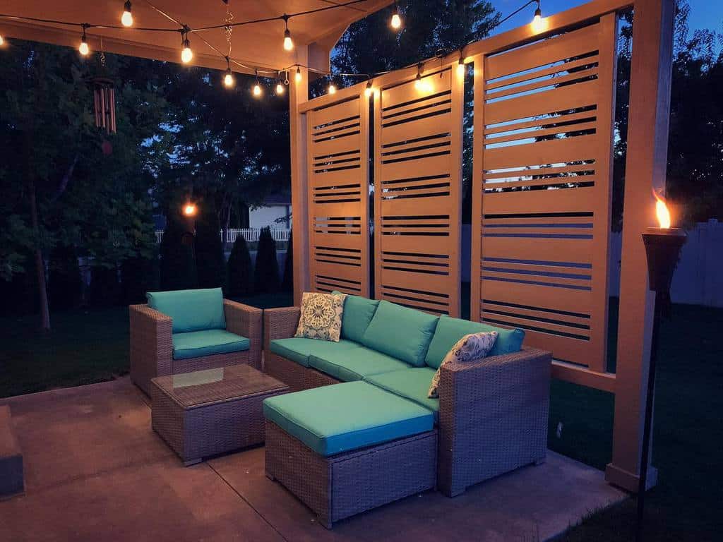 backyard patio wicker furniture privacy wall fire candles 