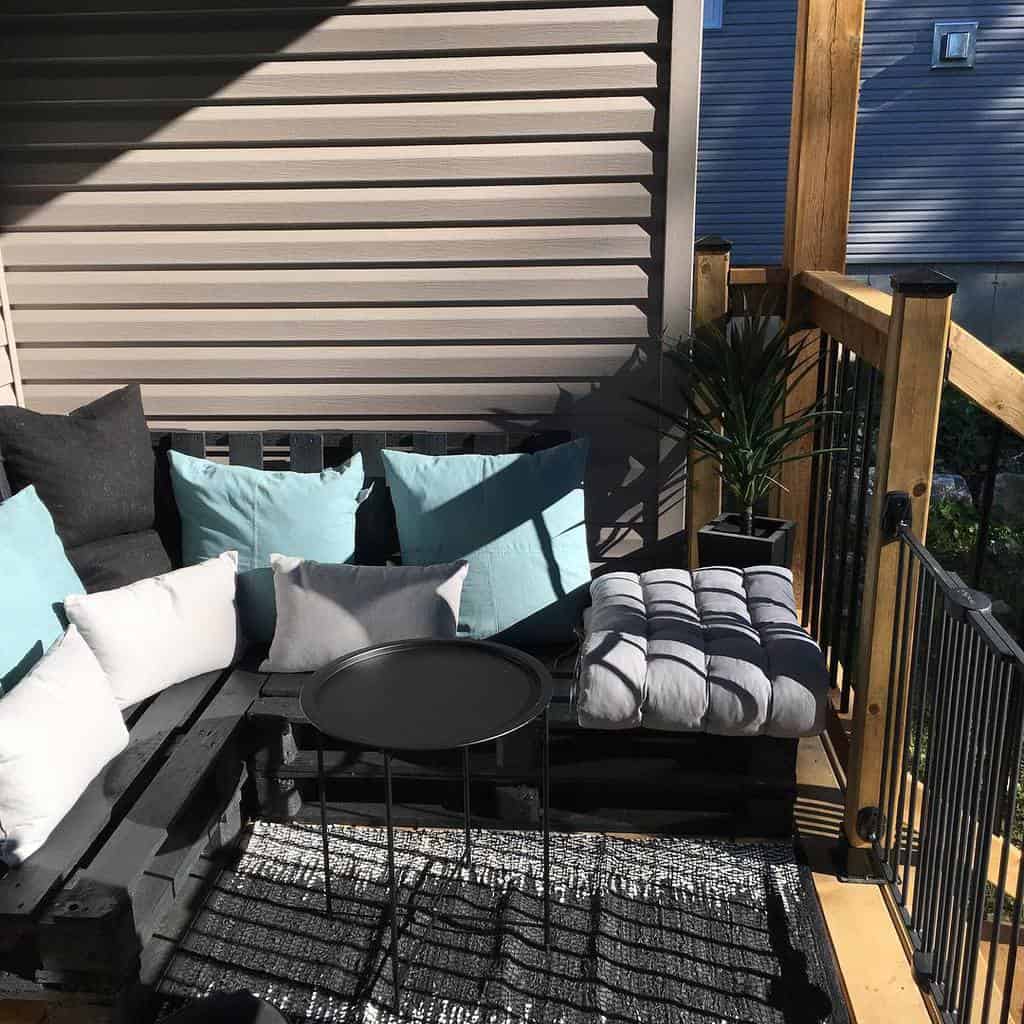 small patio black railing pallet sofa with cushions 