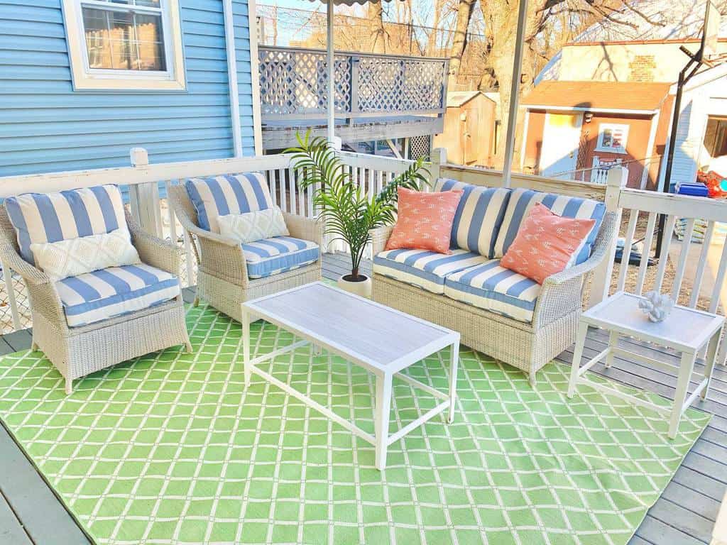 pastel color patio green pattern rug blue and white cushions 