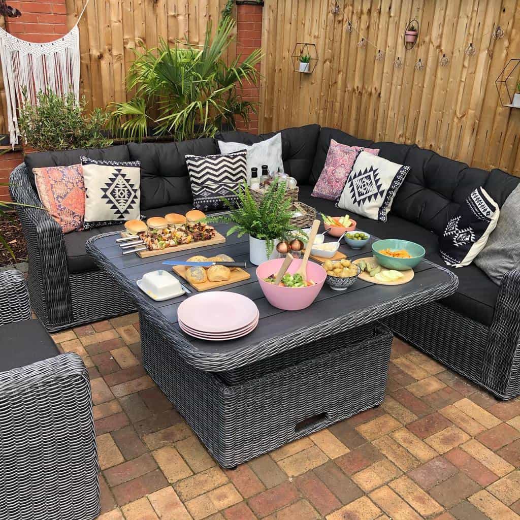 brick paver patio with wicker table and chairs 