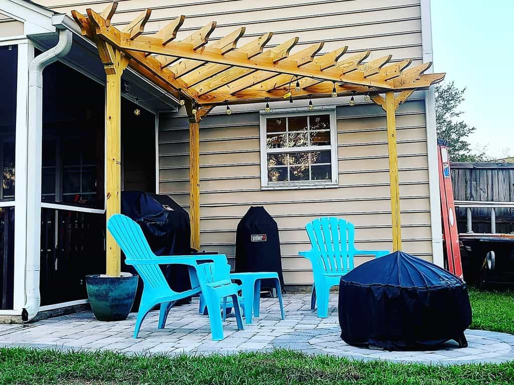 small paver backyard wood gazebo blue chairs covered bbq
