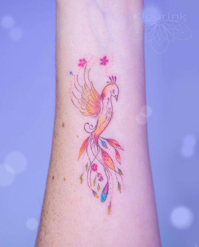 Black feminine rising phoenix and flowers tattoo on girl back