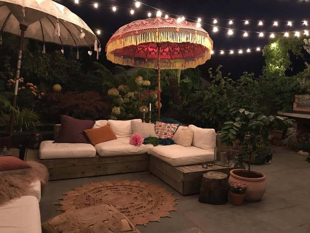 backyard patio garden with wood bench seating and umbrella