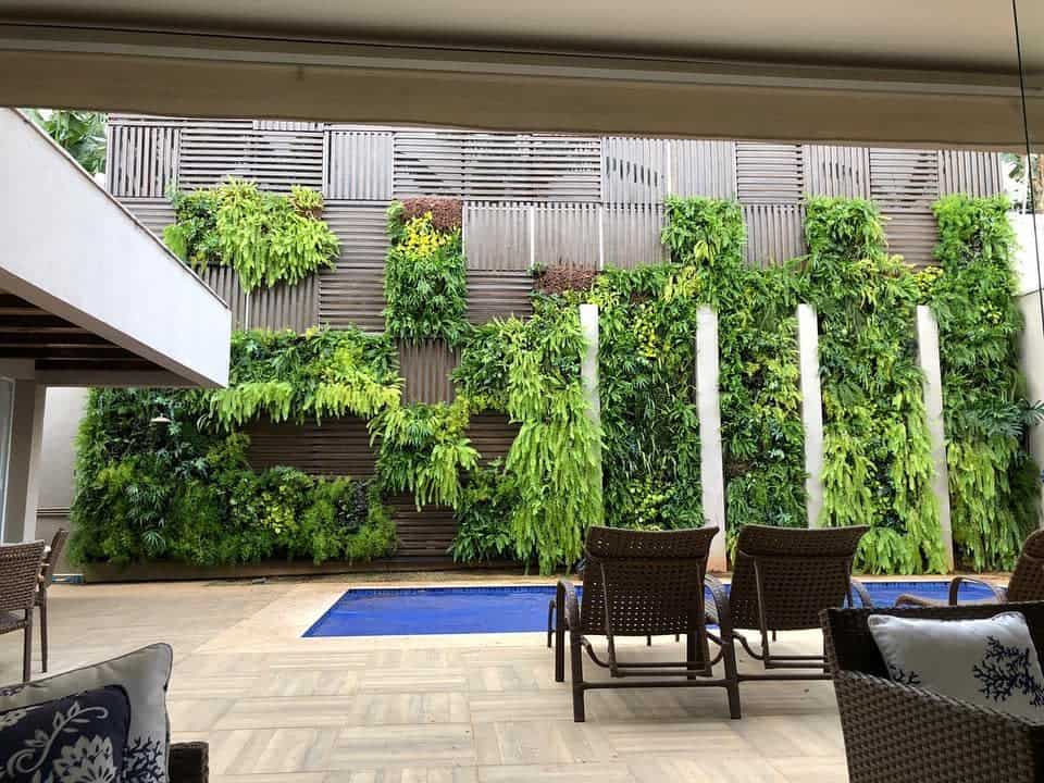 resort style pool wicker furniture vertical garden 