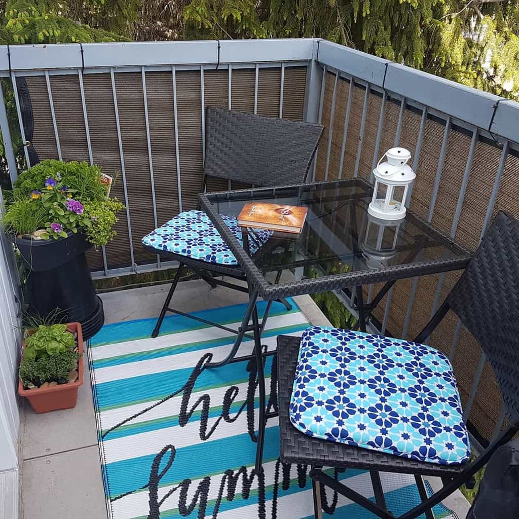 small balcony wicker chairs glass top table planters