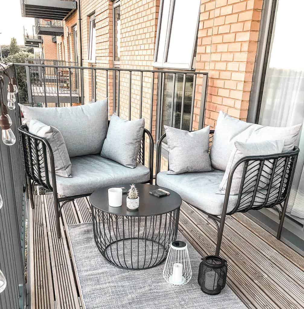 small apartment balcony wood deck two chairs 