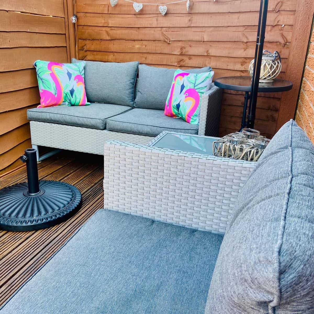 small corner patio deck with wicker furniture 