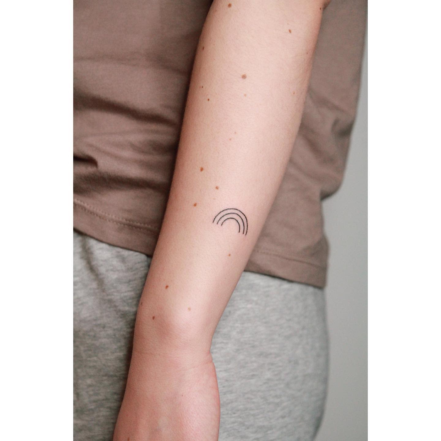 A minimalist black rainbow tattooed on the left hand by Rich Sinner  Rainbow  tattoos Tattoos Triangle tattoos