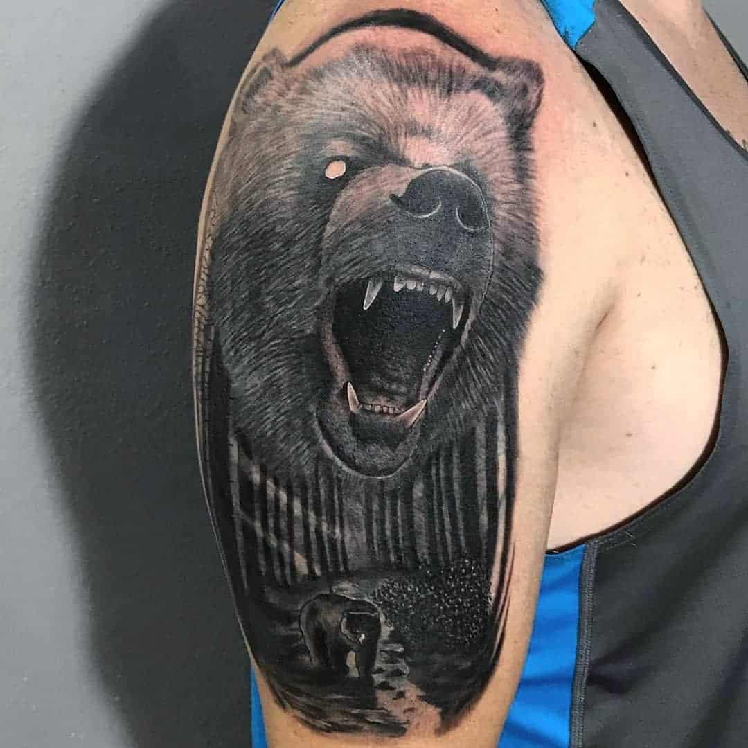Bear in bear paw tattoo on shoulder by Ben Licata TattooNOW