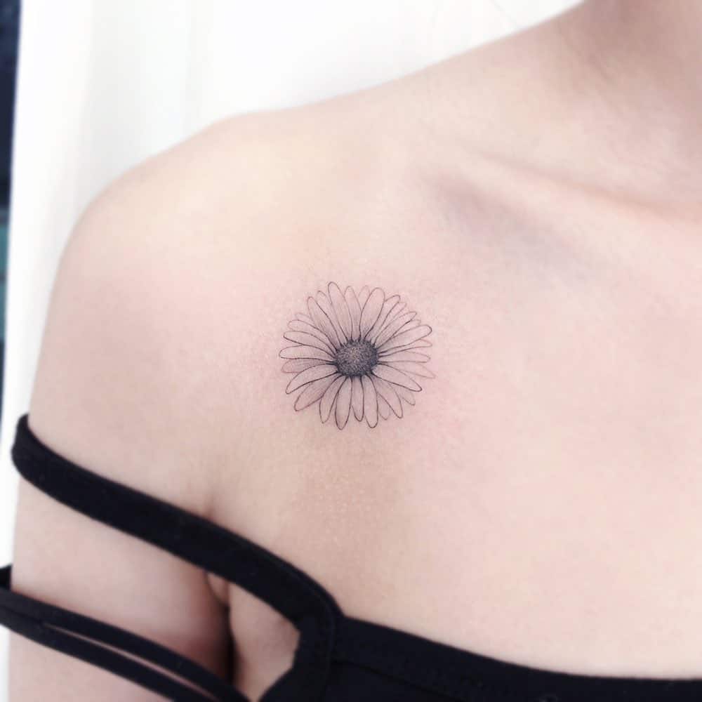 Shoulder tattoo black and grey fine line delicate daisy