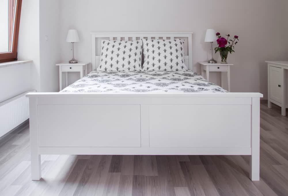 white bed and bedside tables