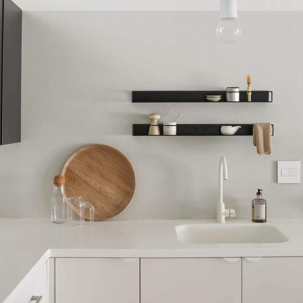 minimalist kitchen with black mounted wall shelves 