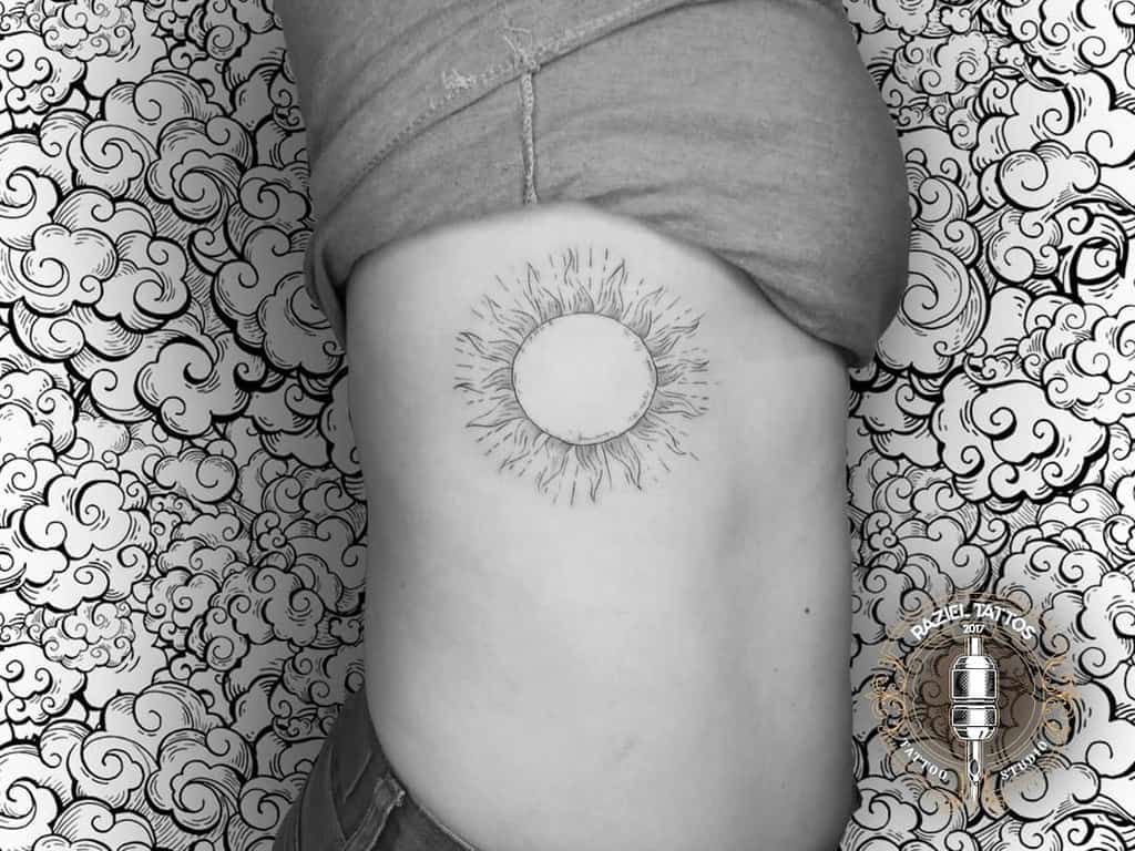 Simple Sun Rib Tattoo razieltattoos