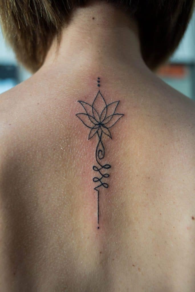 Single Needle Lotus Tattoo On Girls Back