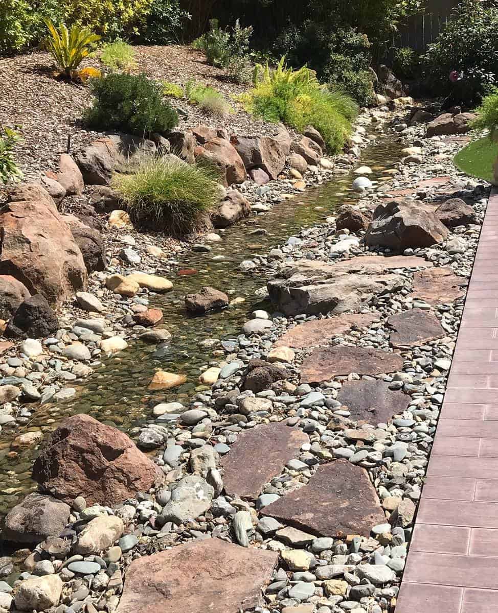 slope garden with small creek and green shrubs