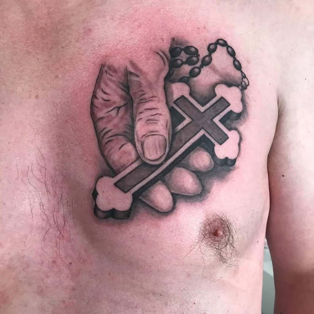 Small cross tattoo chest