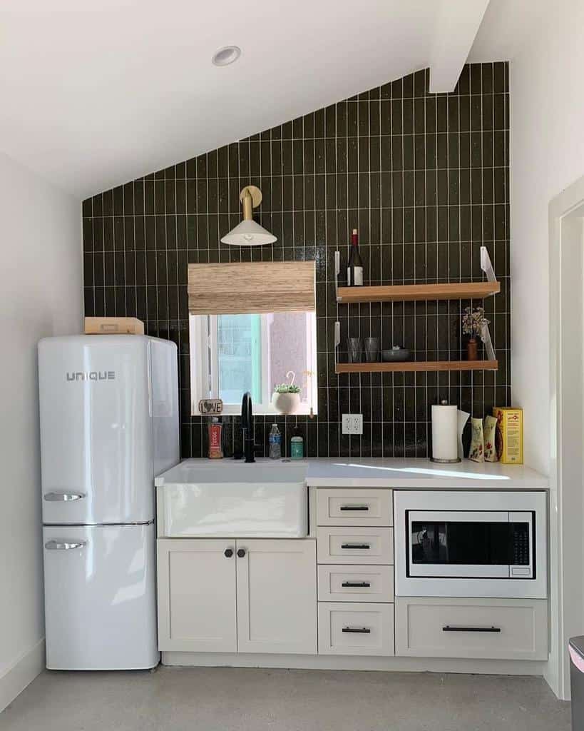 small kitchen brown tile accent wall floating shelves white cabinets apron sink 