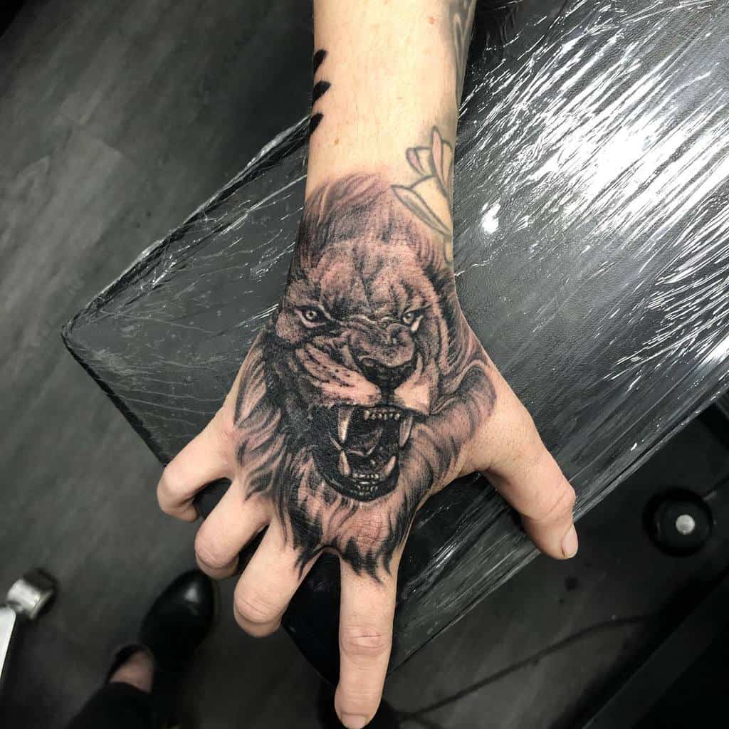 Small Lion Hand Finger Tattoos bobbi_n_tattoo
