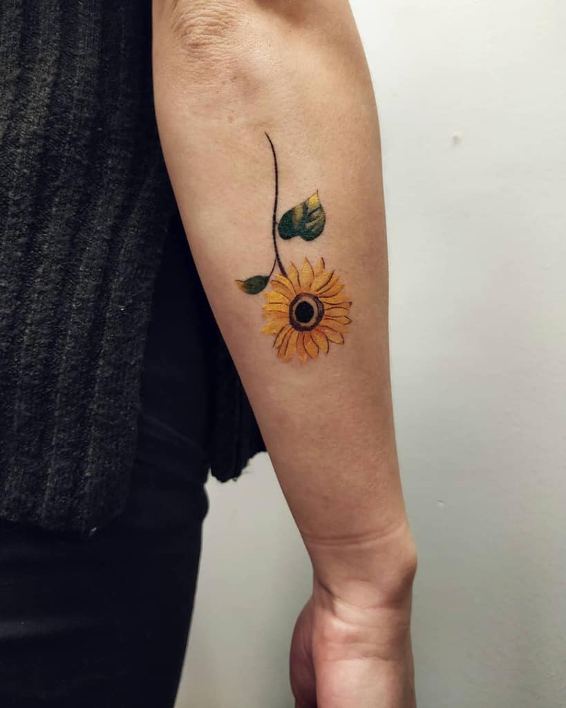 Small sunflower tattoo on the inner arm