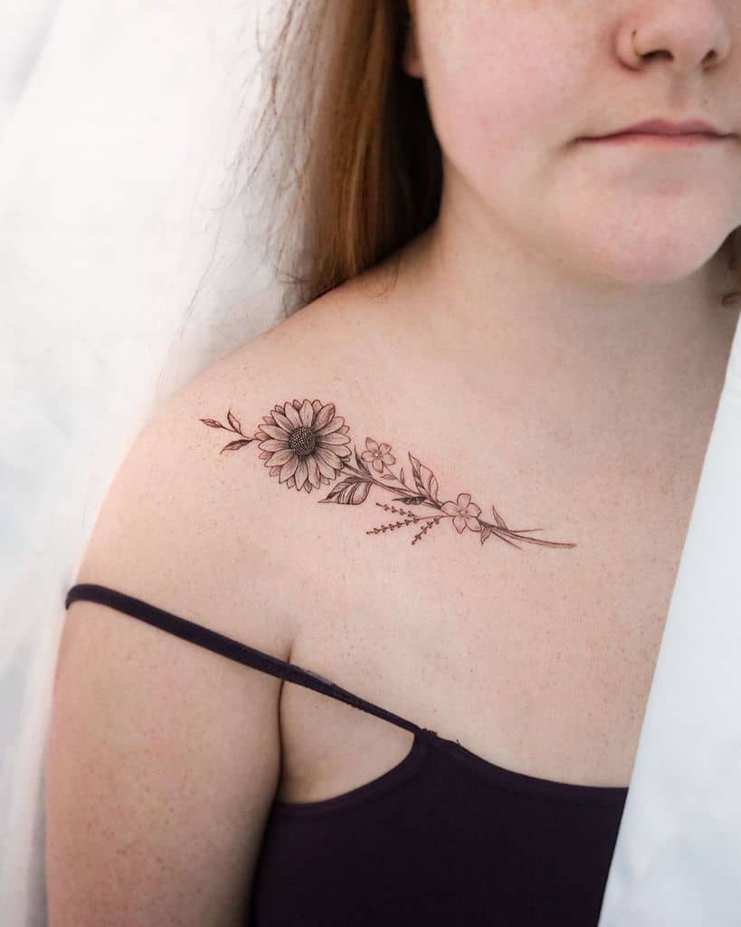 Small sunflower tattoo located on the forearm.