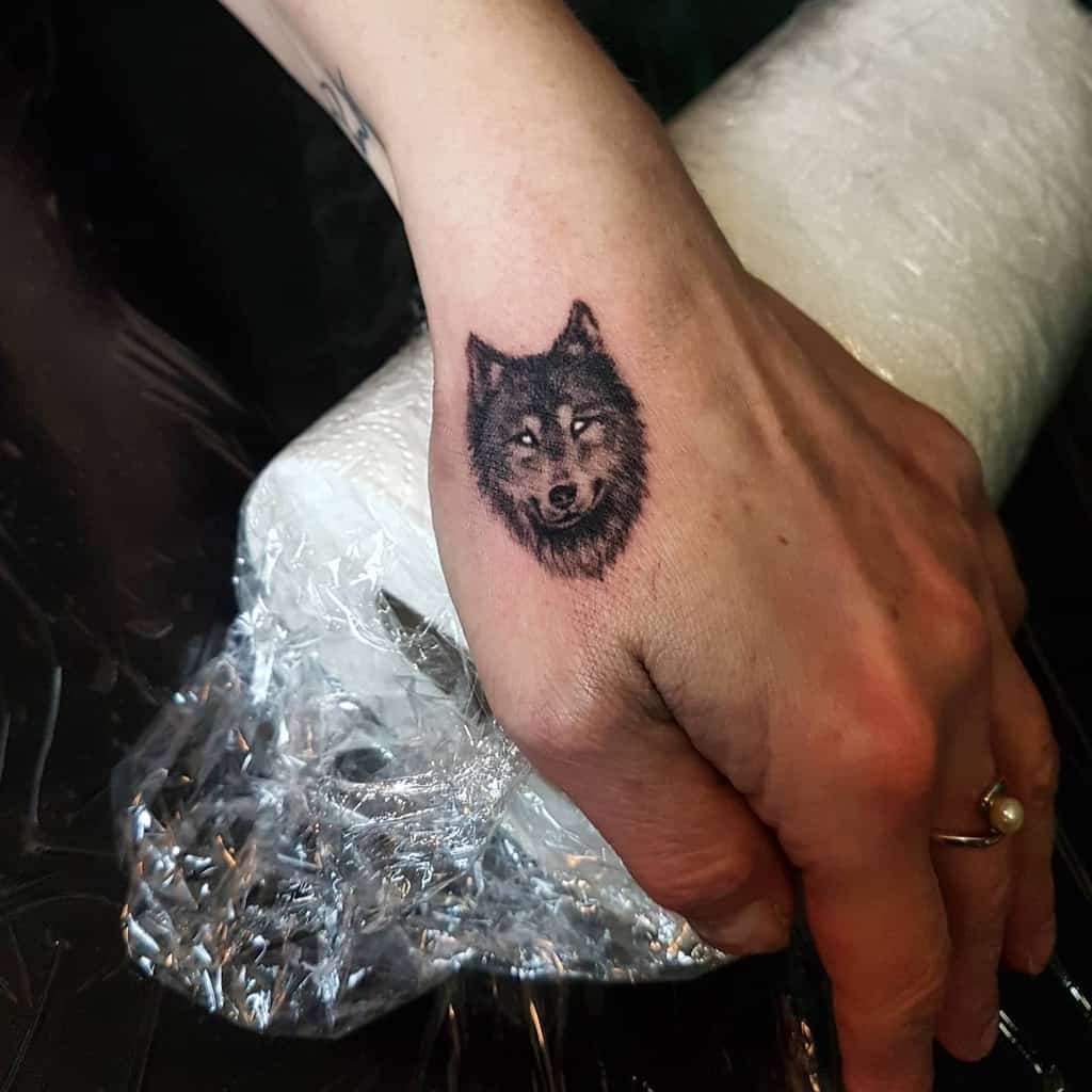 Small Wolf Hand Finger Tattoo artbyrob.p_tattoo