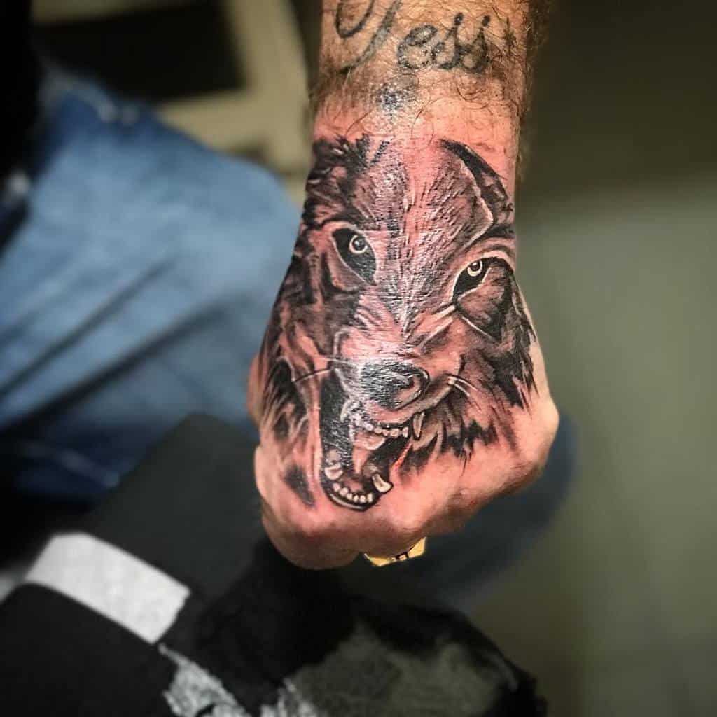 Small Wolf Hand Finger Tattoo skin_gravetattoos