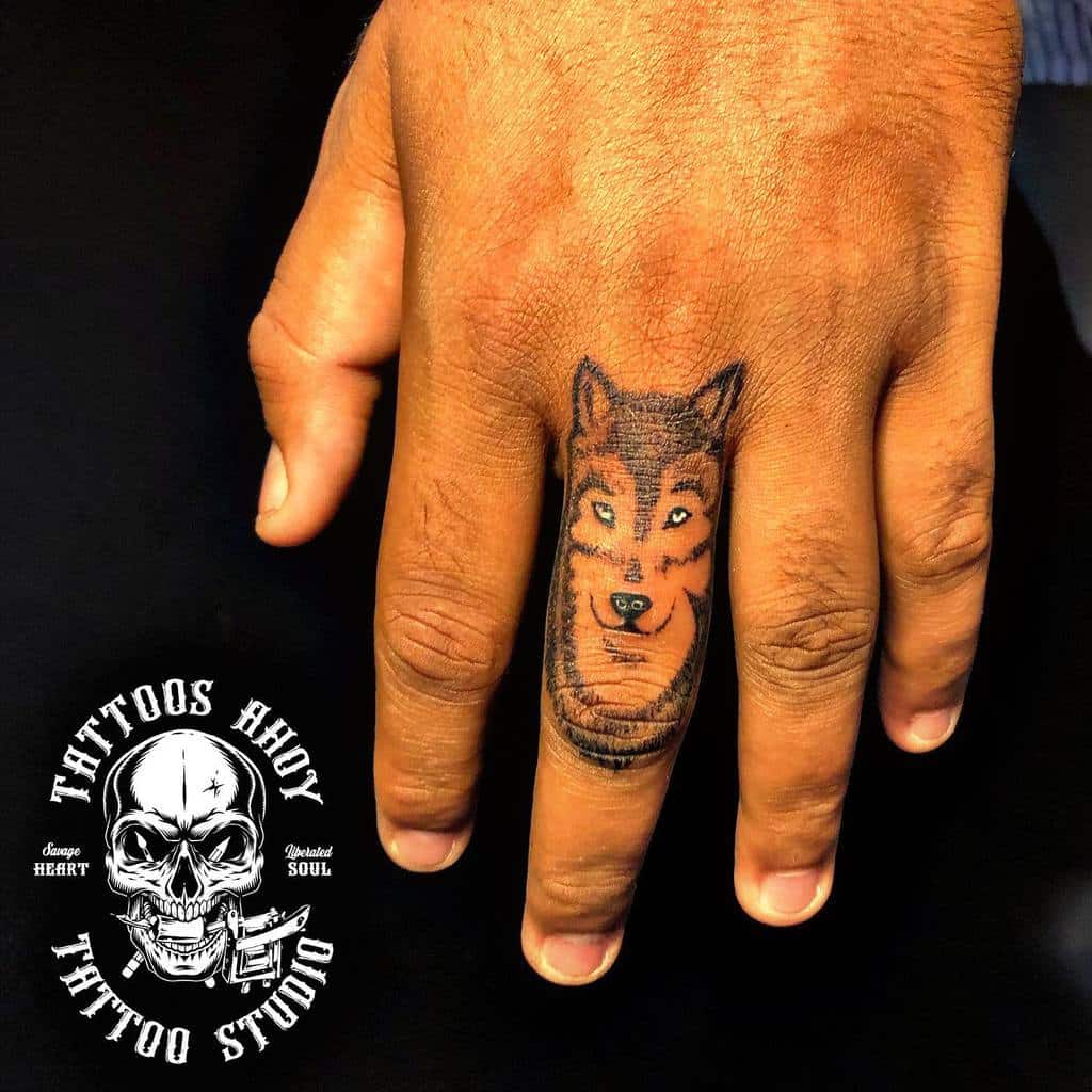 Small Wolf Hand Finger Tattoo tattoos_ahoy