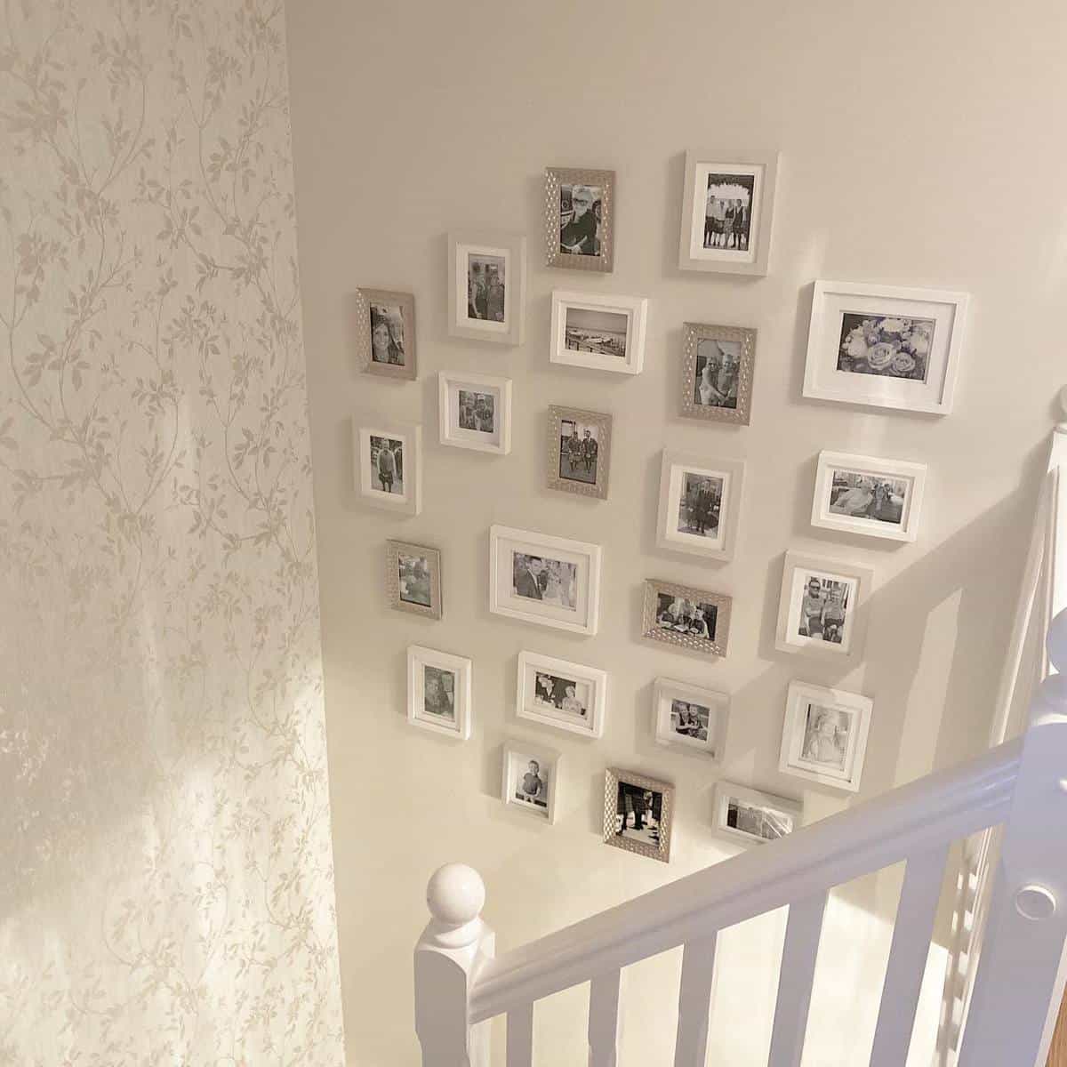 framed photos on wall near staircase 