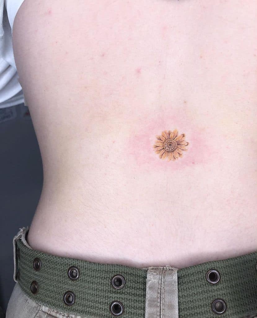 Stomach tattoo tiny color yellow daisy
