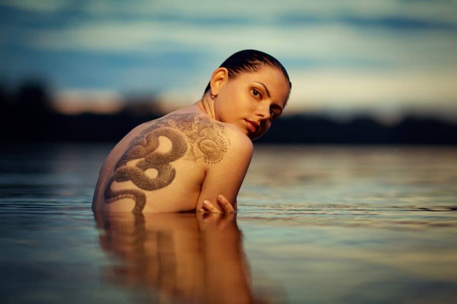 Tattooed Woman In Ocean Pool