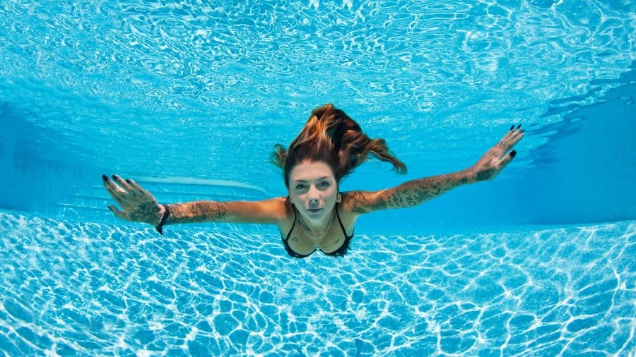 Tattooed_Woman_Swimming_In_Pool