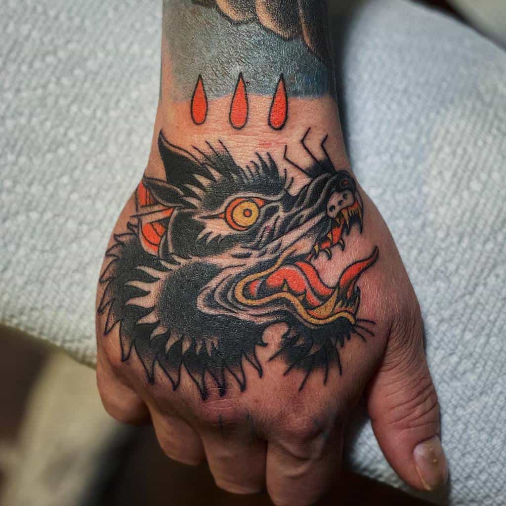 Traditional Wolf Hand Tattoo dancamerontattoos