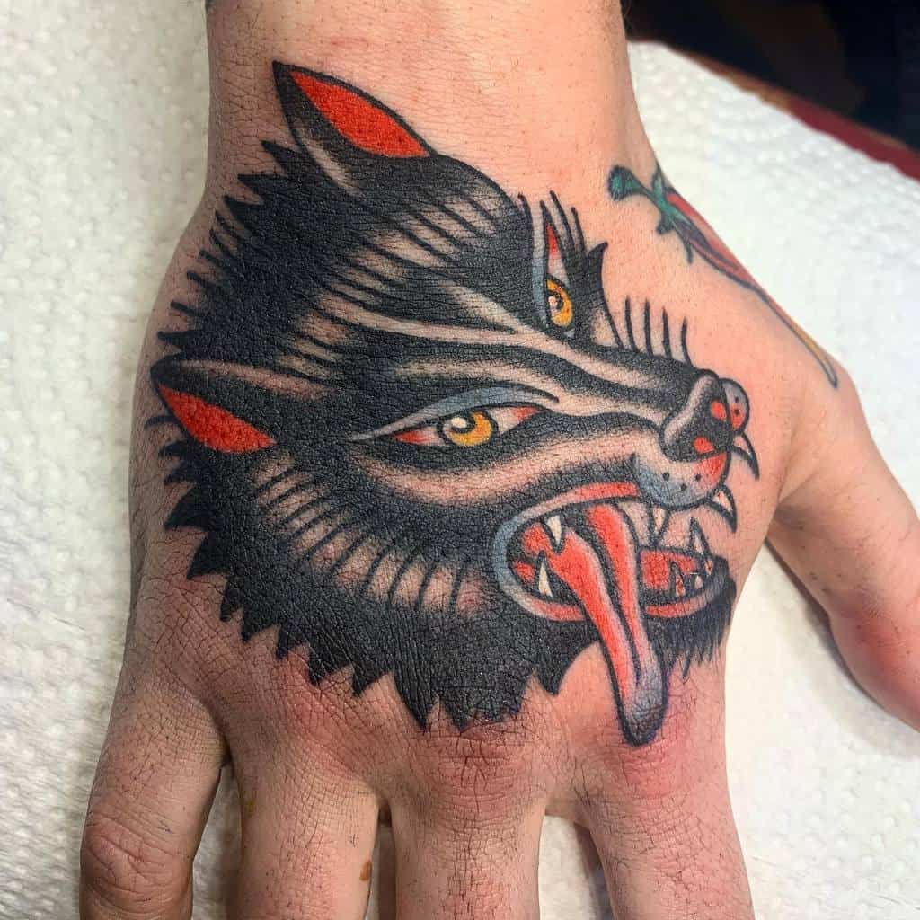 Traditional Wolf Hand Tattoo lennytatoueuse