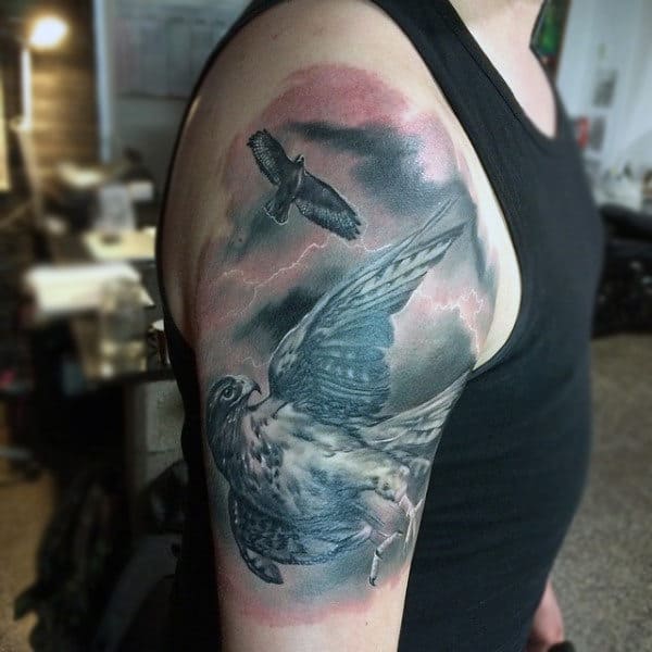 Two Hawks Flying Through Storm Duel Tone Tattoo On Guys Upper Arm