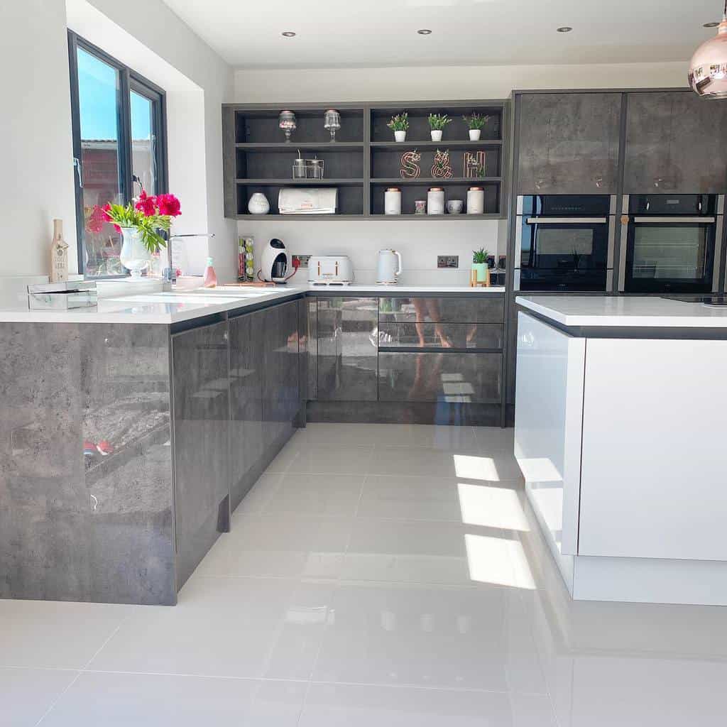 large u-shape modern kitchen glossy gray cabinets white tile flooring white island 