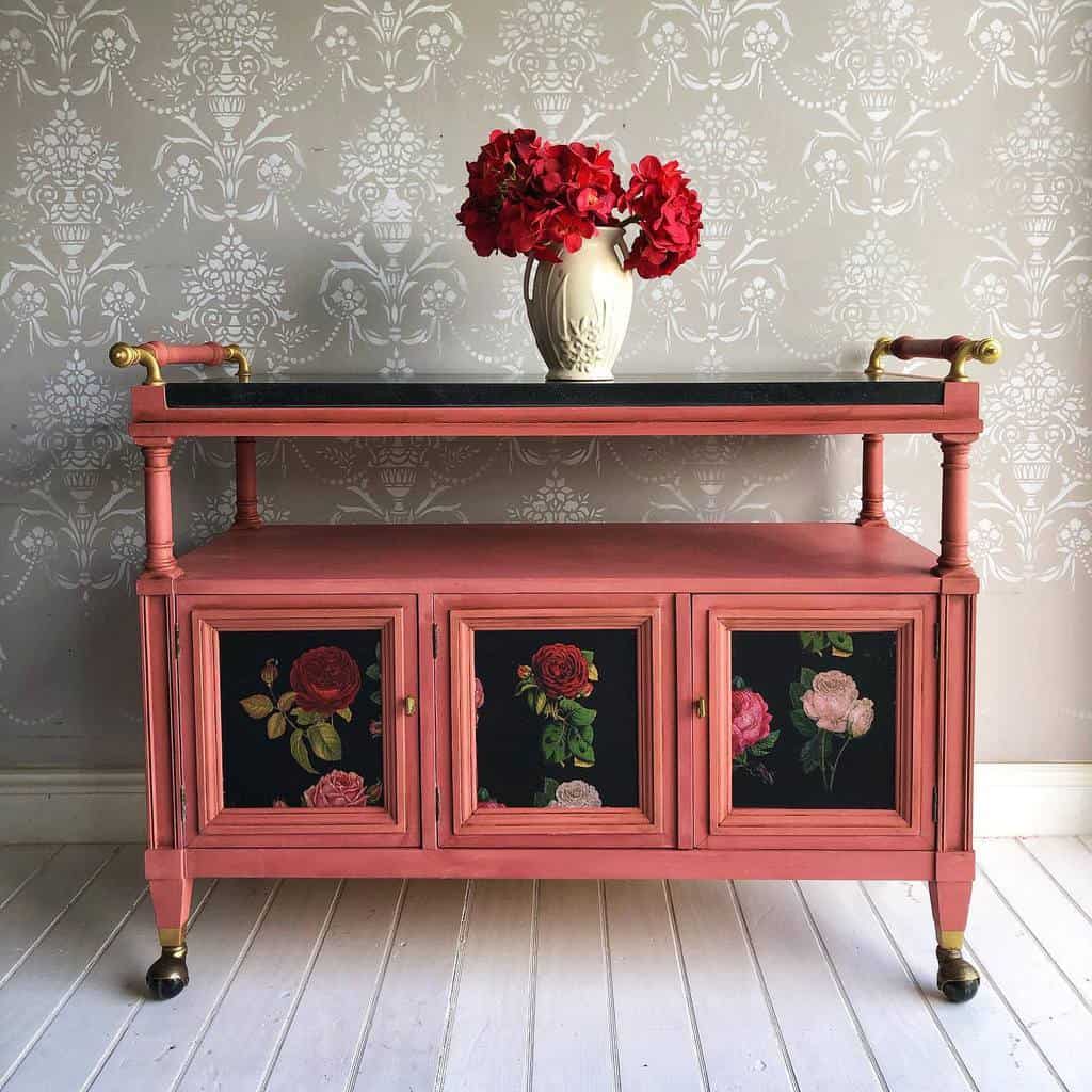 pink bar cart with several built-in draws. 