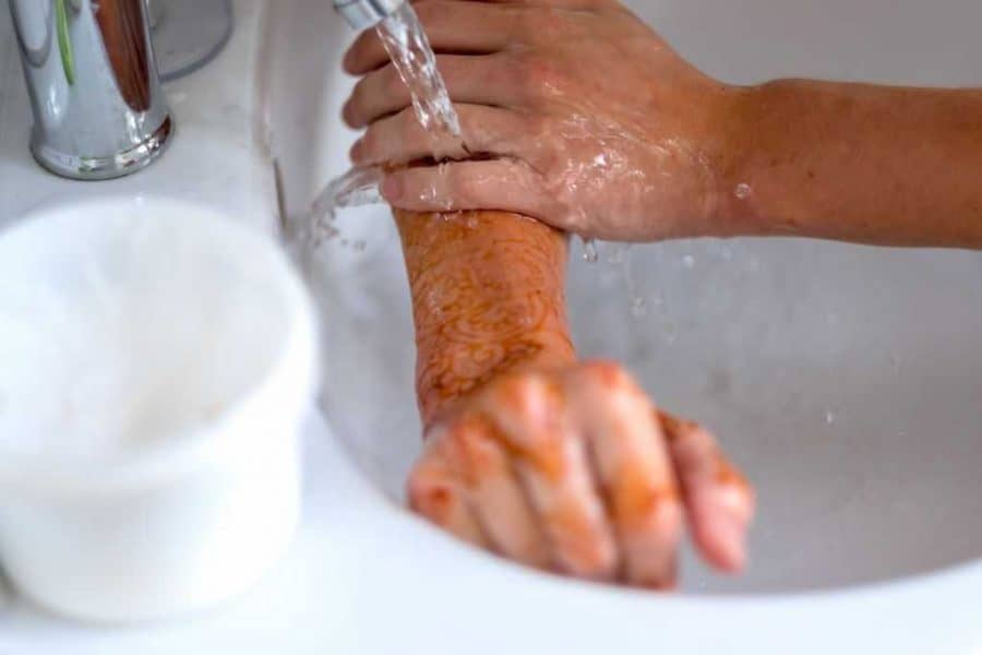 Washing Tattooed Arm In Sink