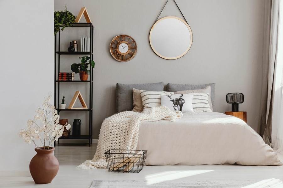 White bedroom with circular mirror