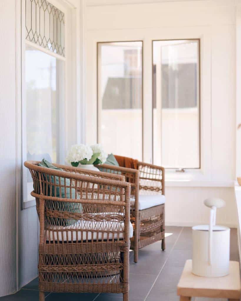 wicker furniture in sunroom with watering tin